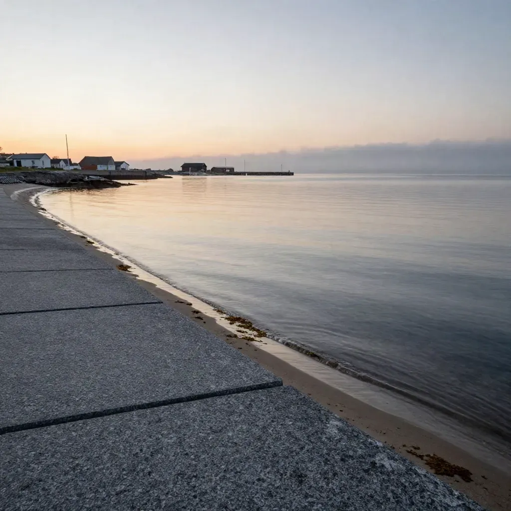 Nordic granite shoreline with hazy harbor forms and pale water at dusk